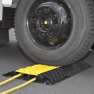 `Heavy duty cable protector with cables in an industrial warehouse area`